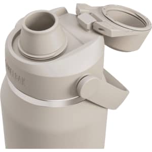 A drink bottle in a muted beige colour, featuring a wide mouth opening and a flip-top lid with a logo.