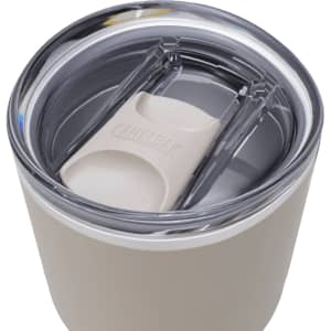 A drink bottle with a stainless steel body and a clear, sealed lid, featuring a logo. Primarily in light beige colour.