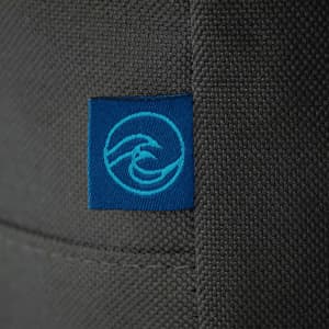 A grey cooler bag featuring a blue logo. The material appears sturdy and textured.