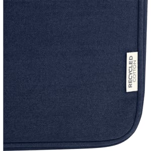 A dark navy recycled canvas laptop sleeve with a small tag indicating recycled cotton.