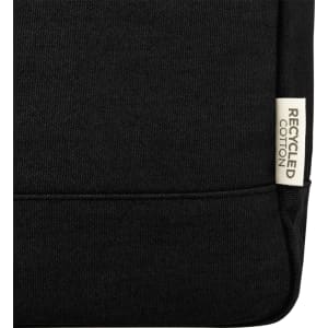 Black recycled canvas backpack tote with a label indicating material. Features sturdy construction and a simple design.