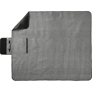 An oversized picnic rug in grey, featuring a black trim and a storage pocket. It has a branding logo.