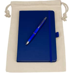 A drawstring bag in cream holds a blue journal book with a matching blue pen on top.