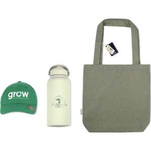 A green cap, a white drink bottle, and a grey tote bag arranged together. The products include branding.