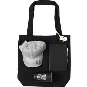 A black tote bag containing a grey cap, a notebook, a pen, and a glass tumbler.