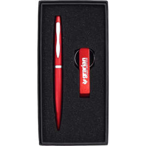 A drink bottle opener keyring and a red pen, both presented in a black gift box with foam insert.