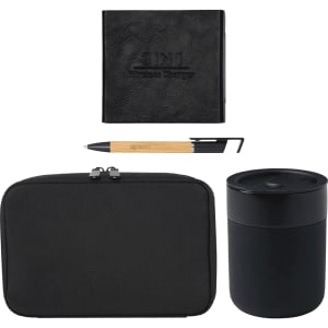 A black tech kit featuring a wireless charger, pen, and a sleek container. Includes a zipped pouch for storage.