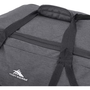 A dark grey duffel bag with sturdy black straps and a logo on the side.