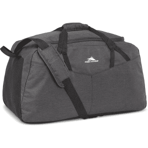 A dark grey duffel bag with a shoulder strap and multiple pockets, featuring a logo on the front.
