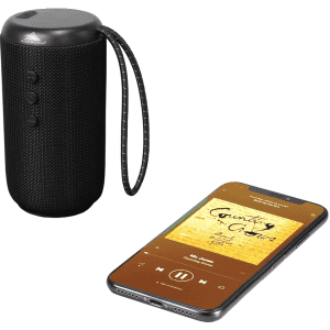 A black cylindrical Bluetooth speaker with control buttons and a phone displaying music playback beside it.
