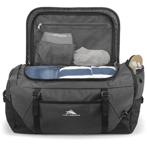 A grey duffel backpack opened to reveal neatly folded clothes and a drink bottle inside. It features a logo on the front.