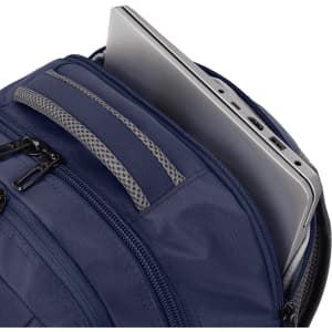 A navy backpack with a laptop partially visible inside, featuring multiple zippered compartments and a logo.