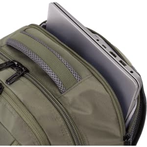 A green backpack containing a laptop in an internal sleeve. It features multiple zippered pockets.