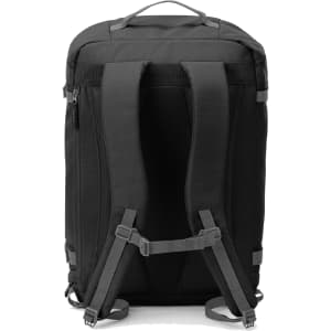 A black travel backpack with padded shoulder straps, featuring a sleek design and various adjustable straps.