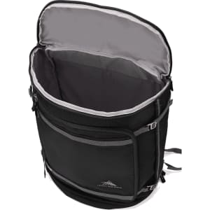 A black travel backpack with a grey interior and zipped compartments, featuring a logo on the front.