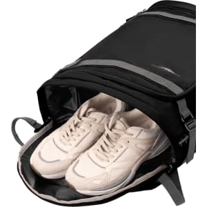 A black High Sierra travel backpack with grey accents, featuring a compartment holding a pair of white sneakers.