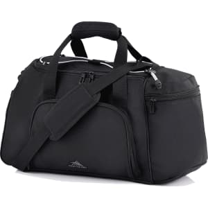 A black travel duffel bag with multiple compartments, handles, and an adjustable shoulder strap. It features a logo.