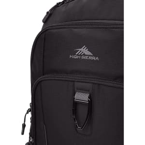 A black backpack featuring a front pocket and a logo. It has multiple zippers and a durable fabric.