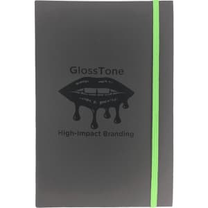 A black journal with a green elastic band, featuring a lip graphic and branding on the cover.