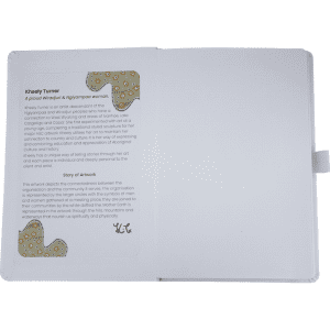 An open journal book featuring a textured white cover, showcasing a page with an artistic design and text.