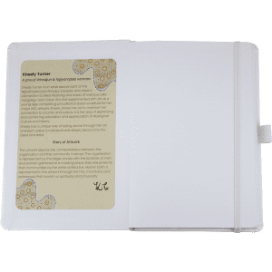 A journal with a white cover and an internal artwork display, featuring a logo and text about the artist and their work.