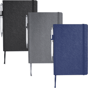 A set of three Modena Bound JournalBooks in black, grey, and navy, each with a pen attached and an embossed texture.