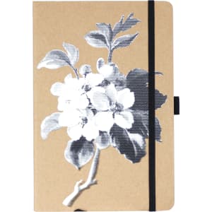 A journal featuring a kraft cover with a floral design in black and white, secured with a black elastic band.