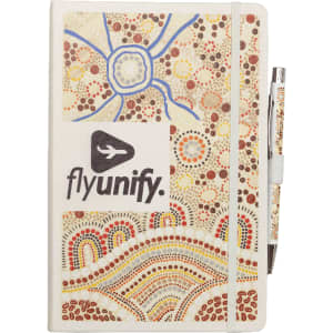 A white A5 journal with a colourful Aboriginal-inspired design and a matching pen. Features a logo on the front.