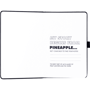 A pineapple leather bound journal with blank pages, featuring a black cover and an interior with printed text.