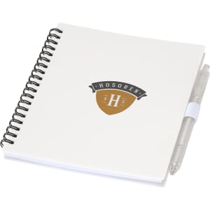 A white spiral-bound journal with a pen attached, featuring a logo on the cover.