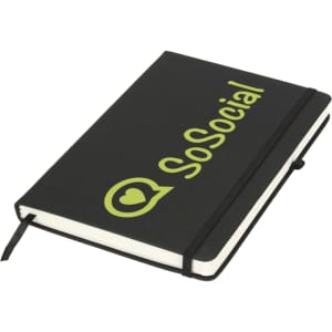 A black journal book with a green logo and text on the cover, featuring a ribbon bookmark.
