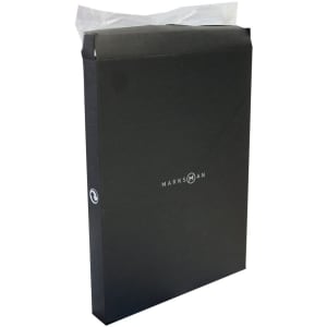A black notebook packaged in a sleek box, featuring a logo on the front and a plastic protective cover.