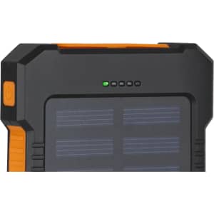 A black and orange solar power bank with a solar panel design and indicator lights on the top.