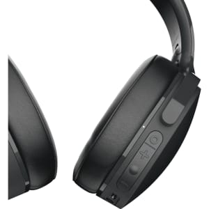 A pair of black wireless headphones featuring controls and a logo, showcasing a sleek design.