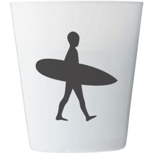 A white candle holder featuring a silhouette of a person walking with a surfboard. The holder has a smooth finish.
