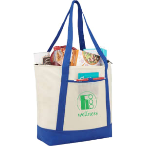 A non-woven boat tote cooler in cream and blue, filled with food and drinks, featuring a logo on the front.