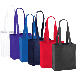 A collection of Mini Elm Non-Woven Tote bags in white, purple, blue, navy, red, and black, each with long handles and branding.