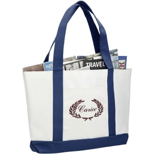 A large white tote bag with navy blue handles and bottom, featuring a decorative logo and filled with magazines.