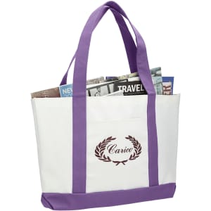 A large tote bag in white with purple handles, featuring a logo and filled with magazines.