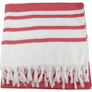 A Turkish beach towel with red and white stripes, featuring decorative fringes along the edge.