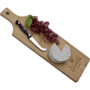 A wooden serving board with a cheese wedge, grapes, and a knife, featuring a logo.