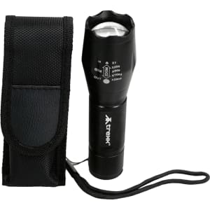 A black Trekk 300 Lumens torch with a textured surface and a carrying pouch. The torch features a strap for convenience.