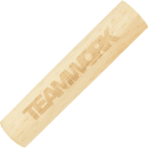 A wooden cylindrical game piece with an engraved "TEAMWORK" design, featuring a light natural wood colour.