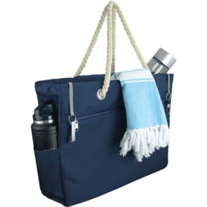 A navy waterproof beach bag with a rope handle, featuring a drink bottle and a towel tucked in.