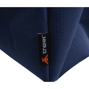 A close-up of a navy blue waterproof beach bag, featuring a small branded tab.