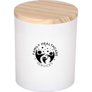 A white candle jar with a wooden lid and a logo on the front, featuring a simple design.