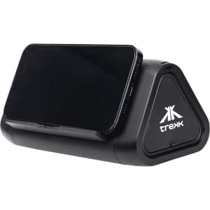 A black outdoor speaker and wireless power bank with a triangular design, holding a smartphone on top.