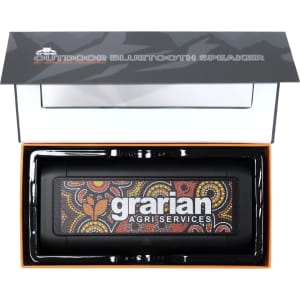 A black outdoor Bluetooth speaker with a colourful Aboriginal art design, presented in a sleek box with branding.