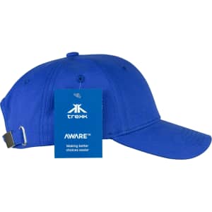 A blue organic cotton twill cap with a curved brim and an adjustable strap at the back. It has a logo and a tag attached.