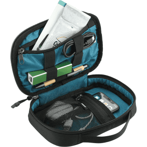A black and teal toiletry bag with various items including a charger, pen, and toiletries neatly organised inside.